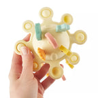 Montessori veiklos žaislas - silikoninė planeta, geltonos spalvos su tampomis spalvotomis dalimis