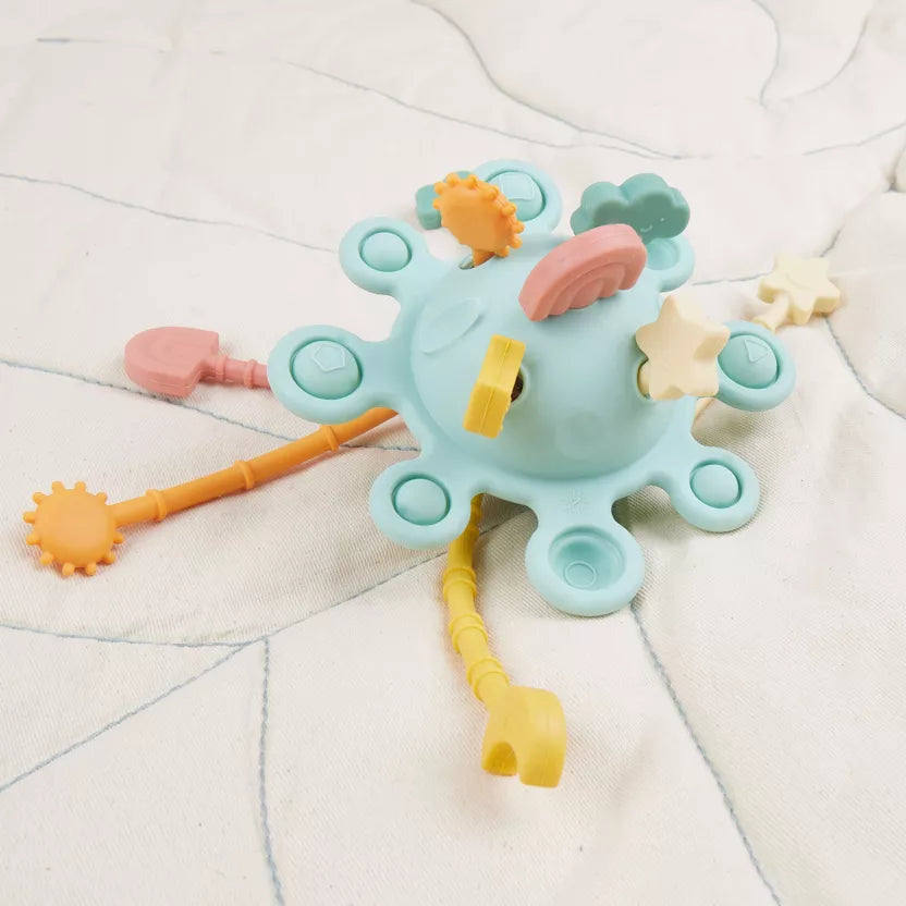 Montessori veiklos žaislas - silikoninė planeta, eukalipto spalvos su tampomis spalvotomis dalimis